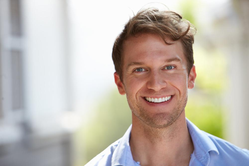 man smiling after dental crown