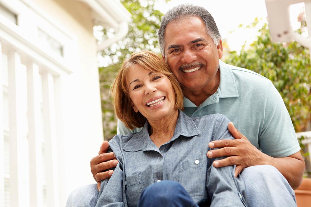 older man and woman smiling