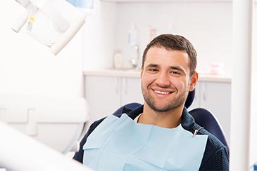 man smiling in dental chair in blacktown