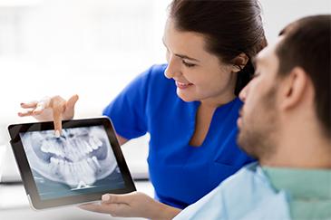 dentist showing patient their digital xrays