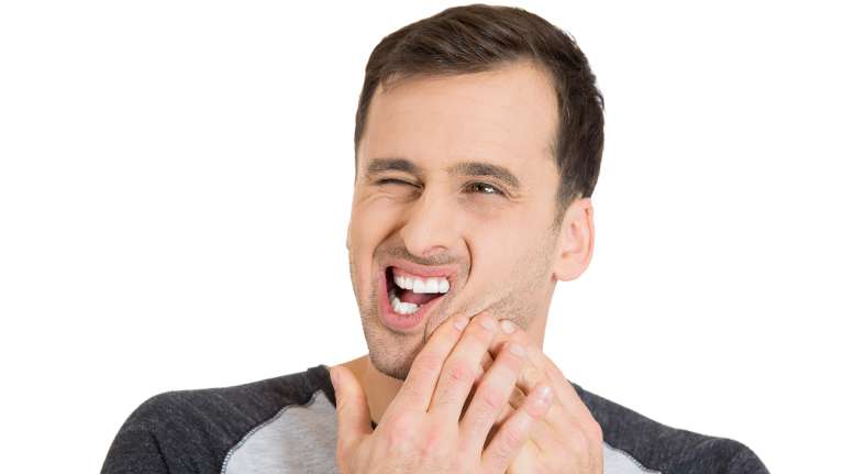 man holding his left cheek