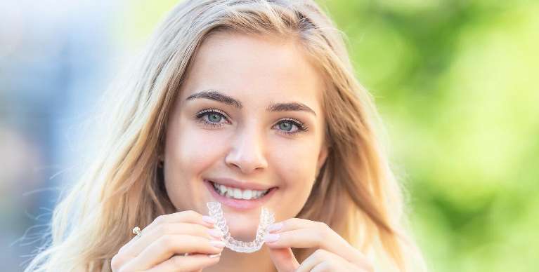 woman using invisalign