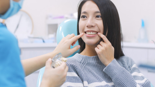 Patient in dental chair pointing to teeth during root canal consultation in NSW dental clinic
