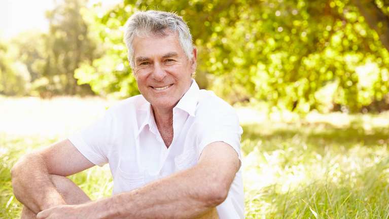 man smiling after dental implants