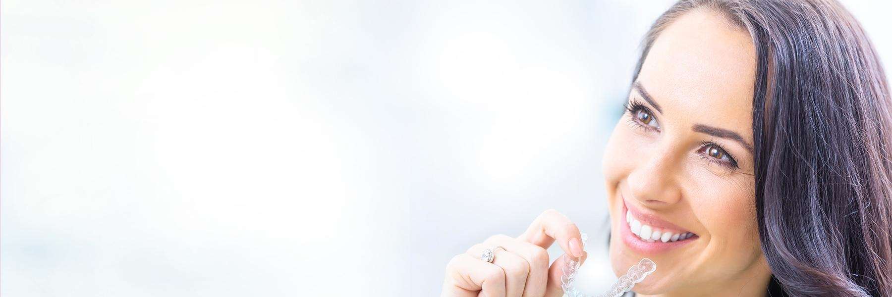 woman smiling while using invisalign 